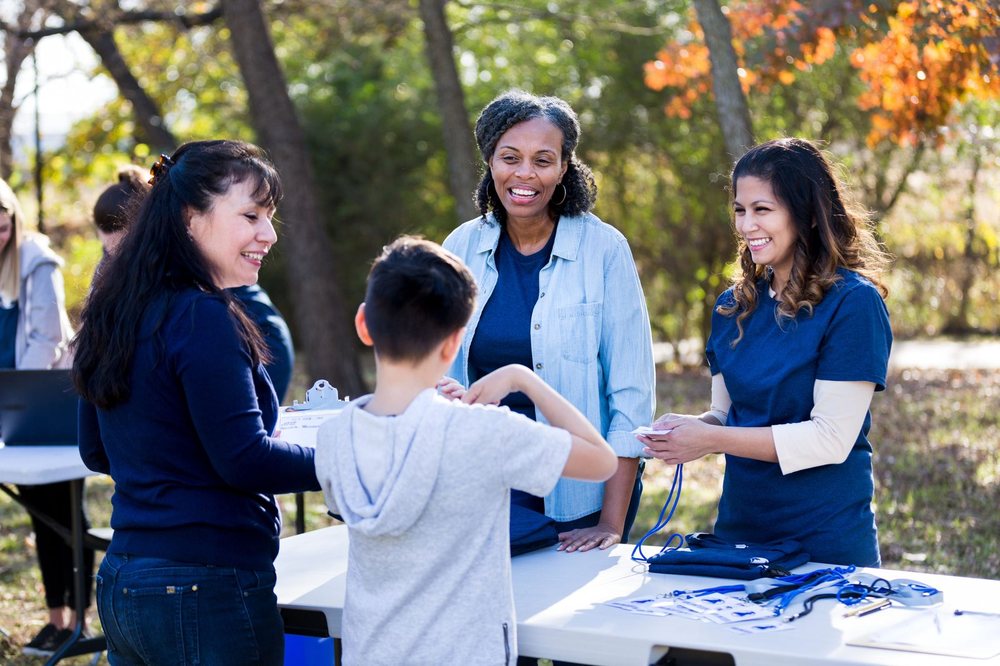 Parent volunteers helping at a school event table